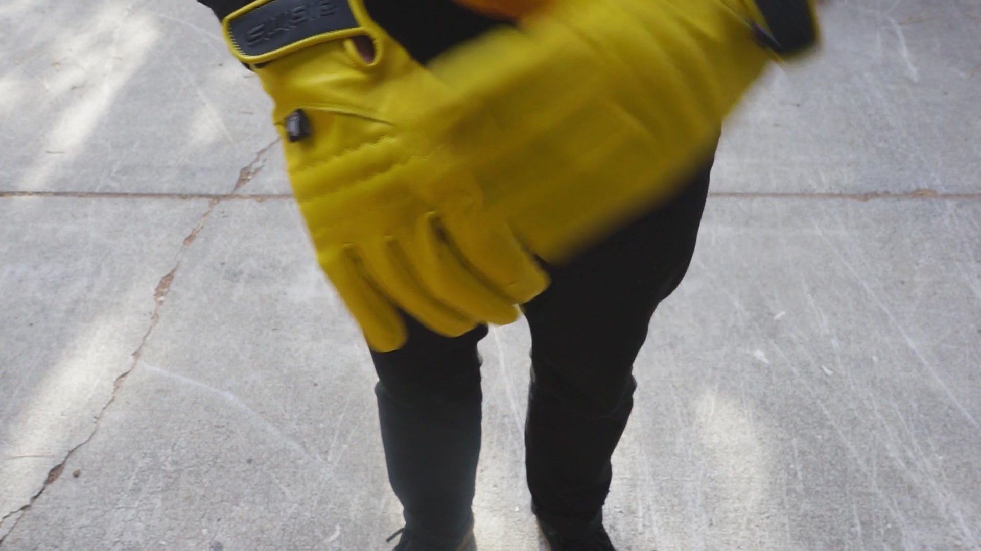 Load video: A worker slides on Digits Workwear non-insulated leather gloves, adjusting the fit. Close-up details highlight the durable leather, reinforced stitching, and flexible design, showcasing the gloves&#39; grip, protection, and comfort.